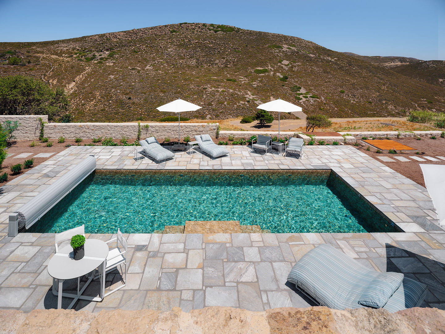 Salt-water swimming pool with mountain views at Patmos villa