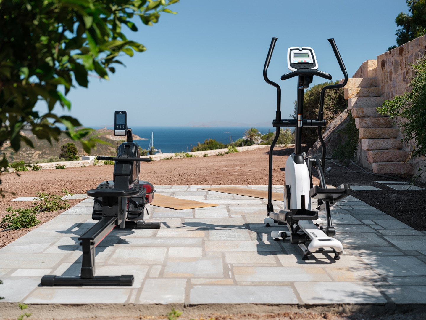 Outdoor gym with exercise bike and weights at Patmos villa retreat