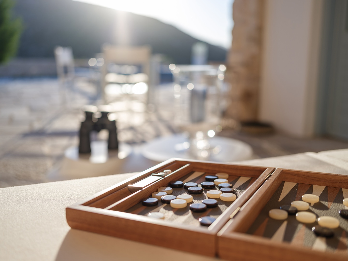 Wine glasses on terrace overlooking Kampos Bay in Patmos