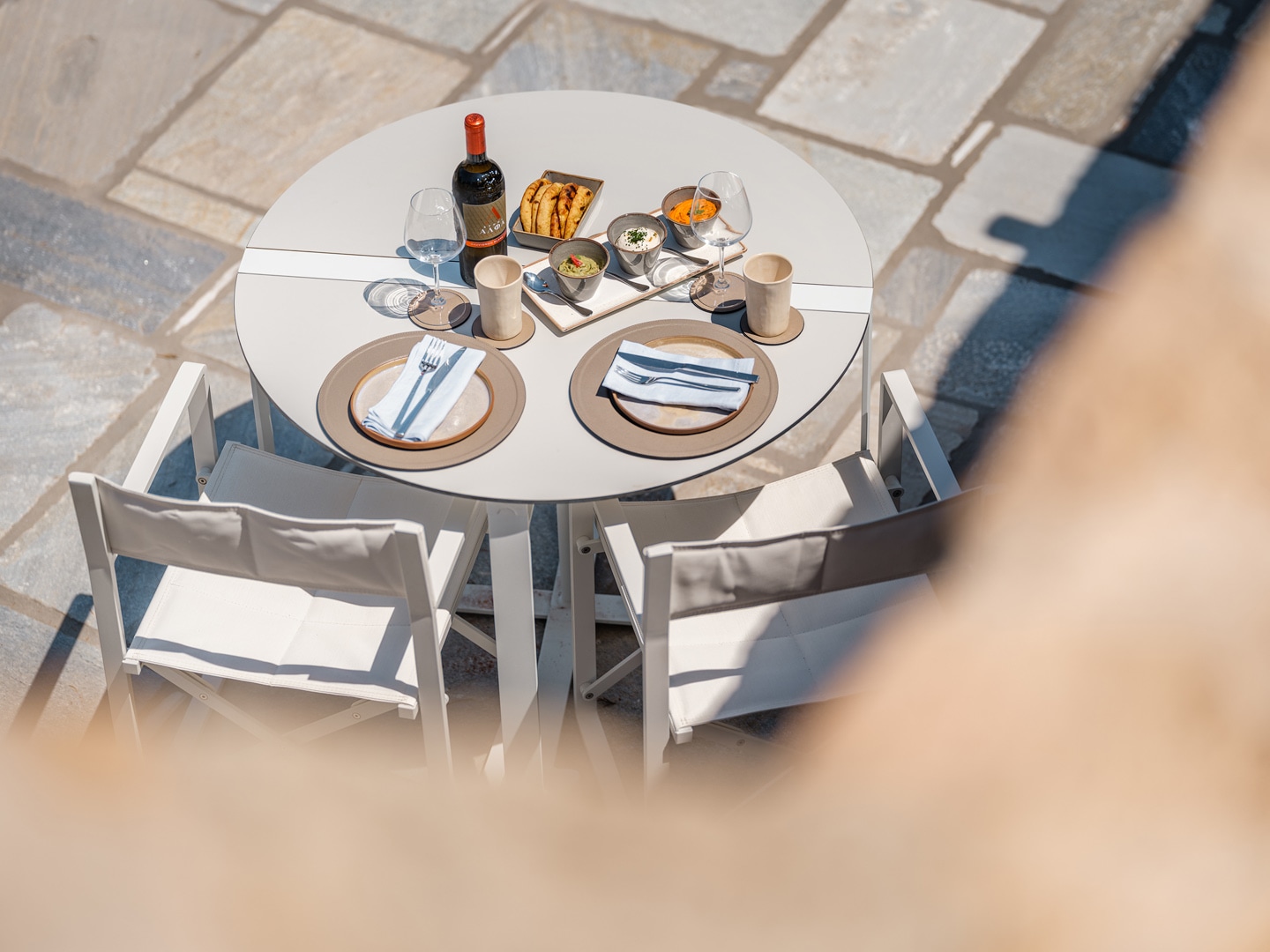 Romantic outdoor dining setup with wine glasses at Patmos villa