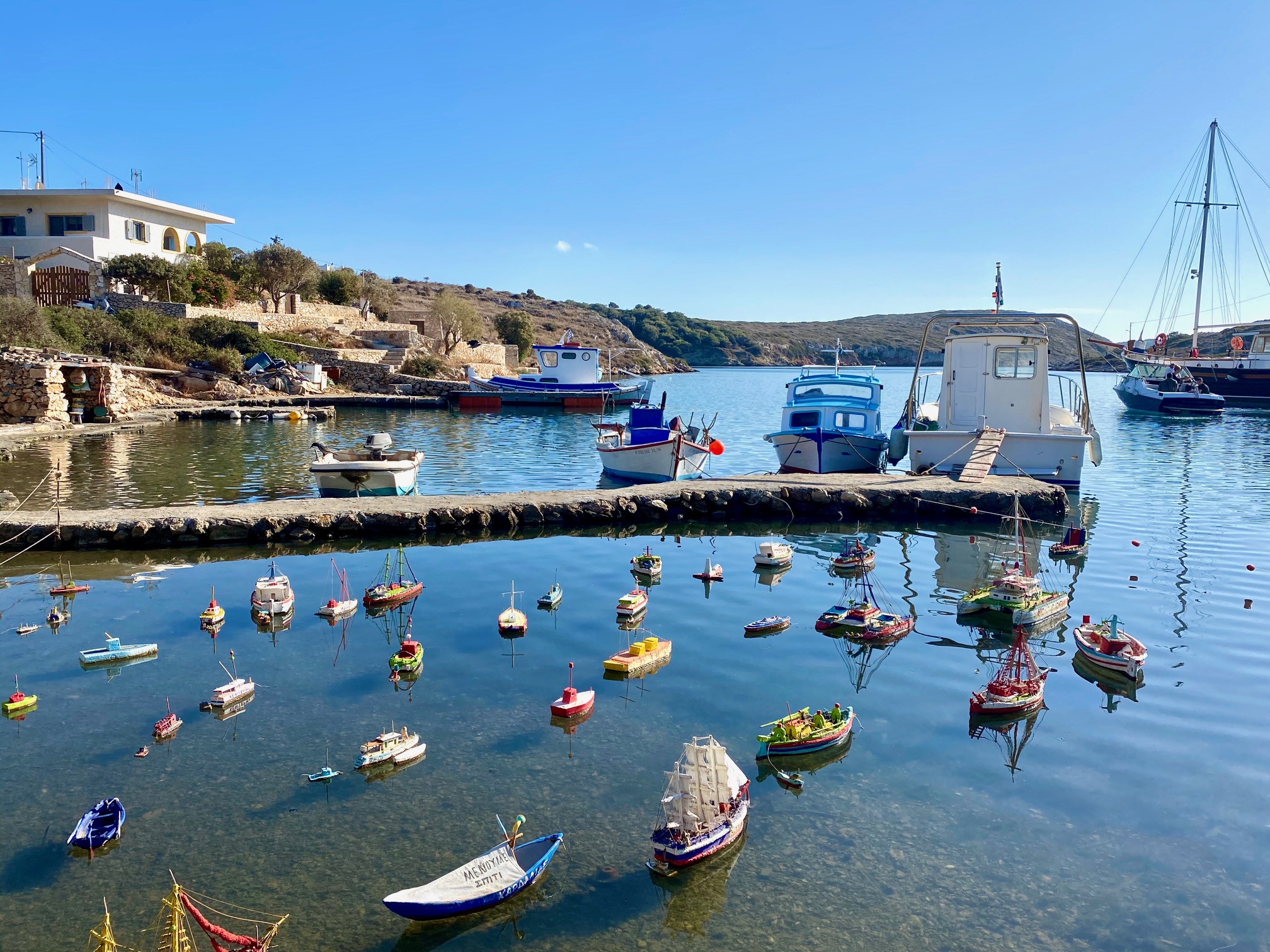 Sandy coastline and calm bay waters at Kampos Beach in Patmos