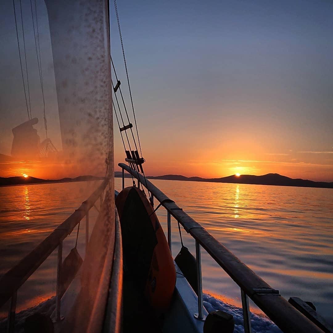 Sailing boat at sunset near Patmos island – romantic Aegean holiday experience
