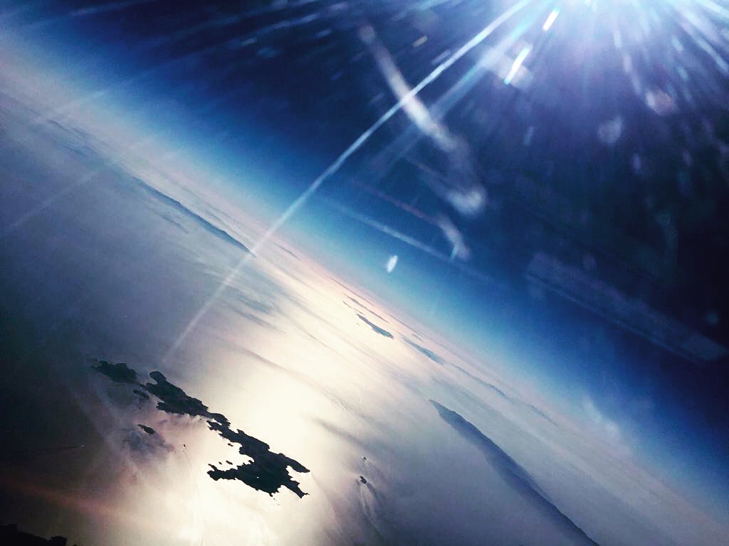 Airplane flying above the Aegean with sunlight reflection en route to Patmos