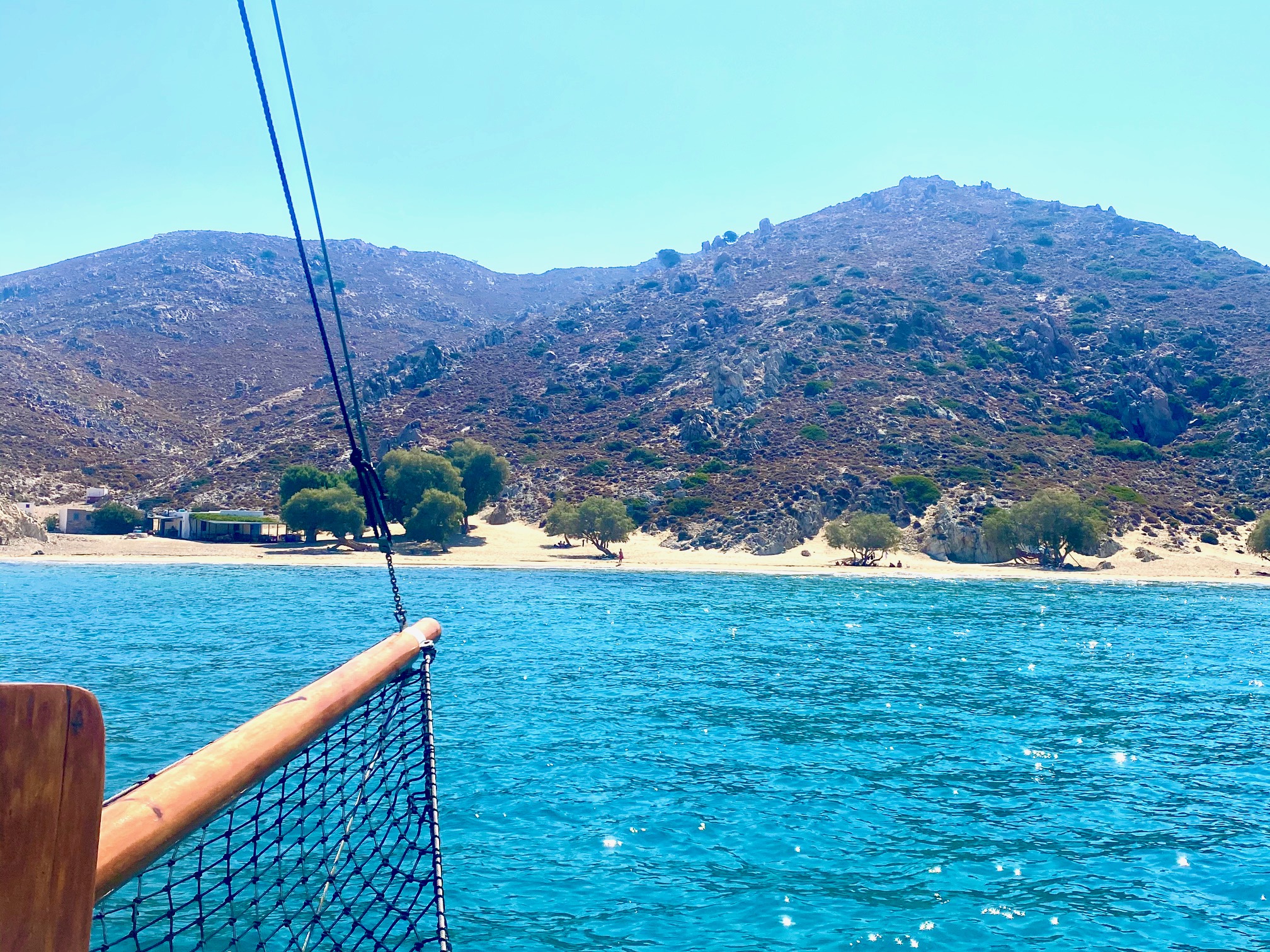 Sailing yacht on blue waters approaching Patmos island