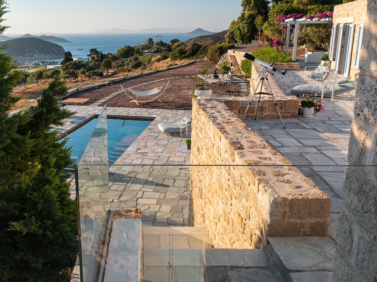 Secluded salt-water pool and villa stone terrace in Patmos