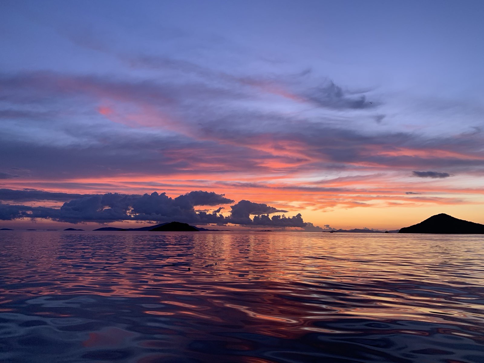 Dramatic sunset with pink and purple clouds over the Aegean Sea in Patmos