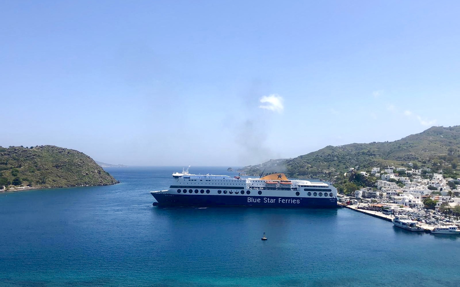 Ferry boat docked at Patmos island harbor on a sunny day