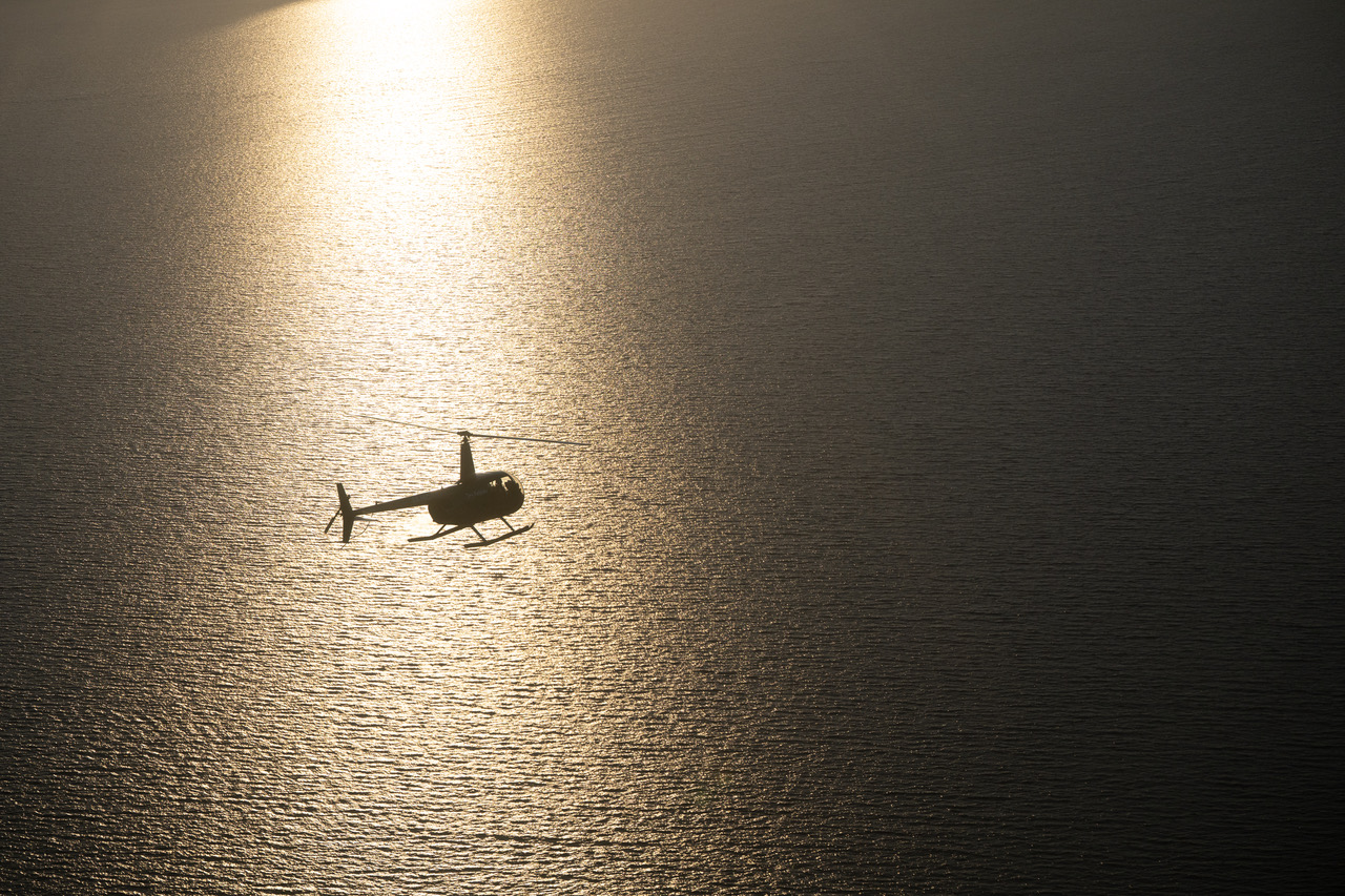 Kayaker in golden sunset waters near Patmos island