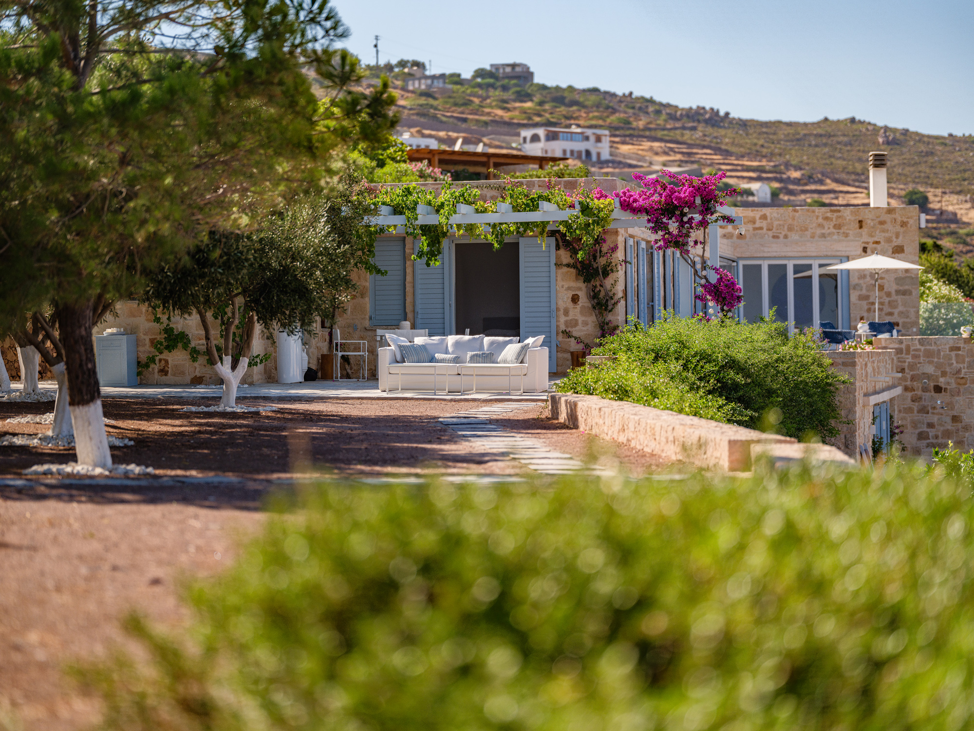 Garden view of luxury Patmos villa with pool and bougainvillea flowers