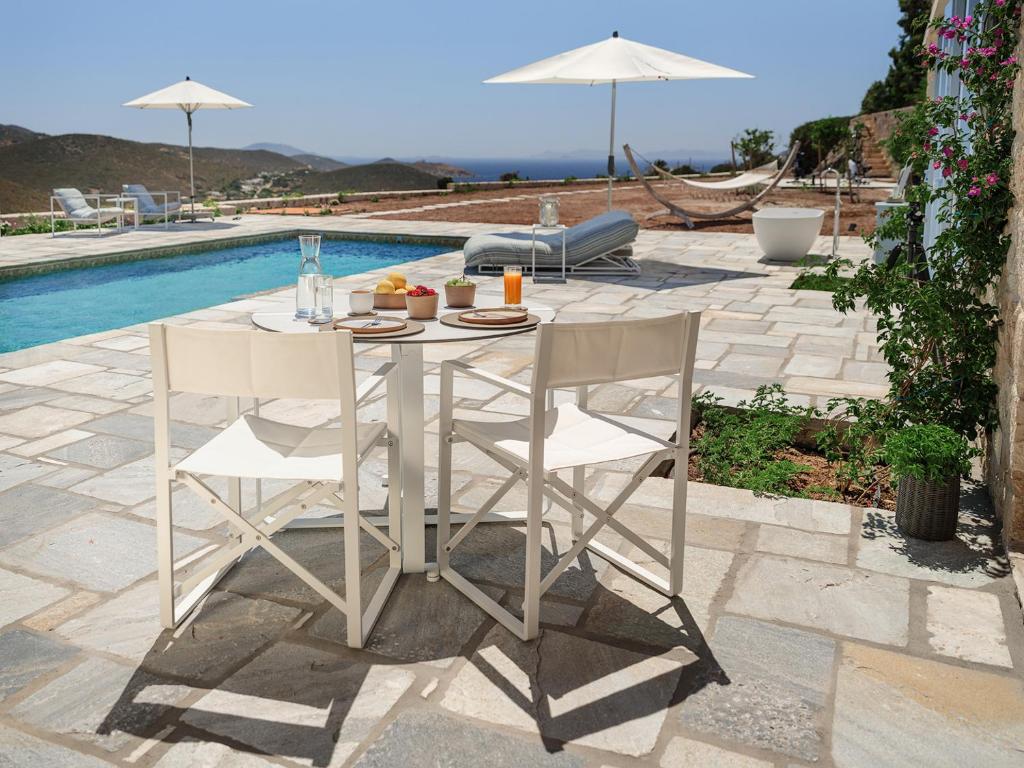 Outdoor dining table with fresh breakfast by the pool at Patmos luxury hideaway